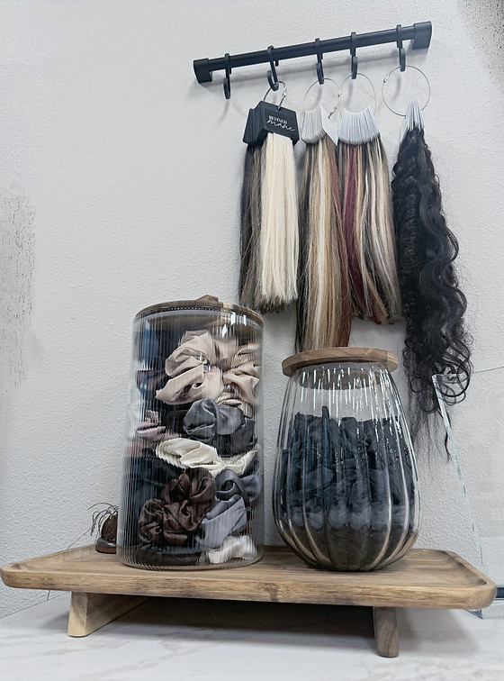 hair extension ring display with a container of scrunchies