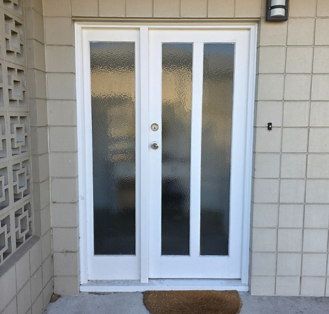 Old timber door about to be replaced with a new aliuminum door