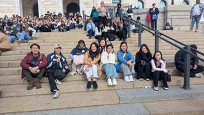 Students sitting on the front steps of the Minnesota State Capitol.