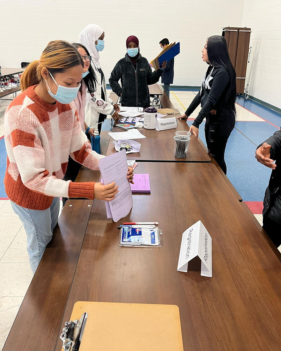 Image of GAP School student organizing vaccine consent paperwork