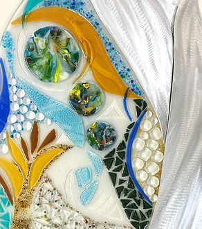 Close-up detail of Arabesque II showing handcrafted fused glass with planetary imagery, bubble forms, and layered color and texture.
