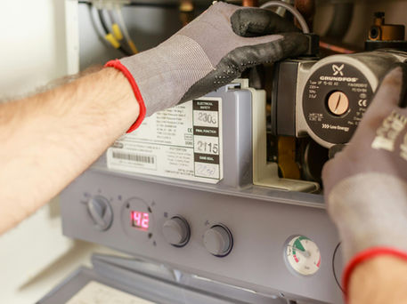 Gas engineer repairing a domestic boiler