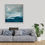 Thumbnail: An atmospheric seascape with a grey sky. The navy sea has green turquoise colour pops framed on the wall over a sofa