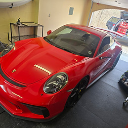 Red Porsche GT2 in a home garage