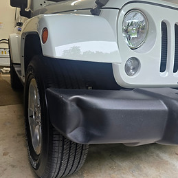Dent in a Jeep Wrangler bumper