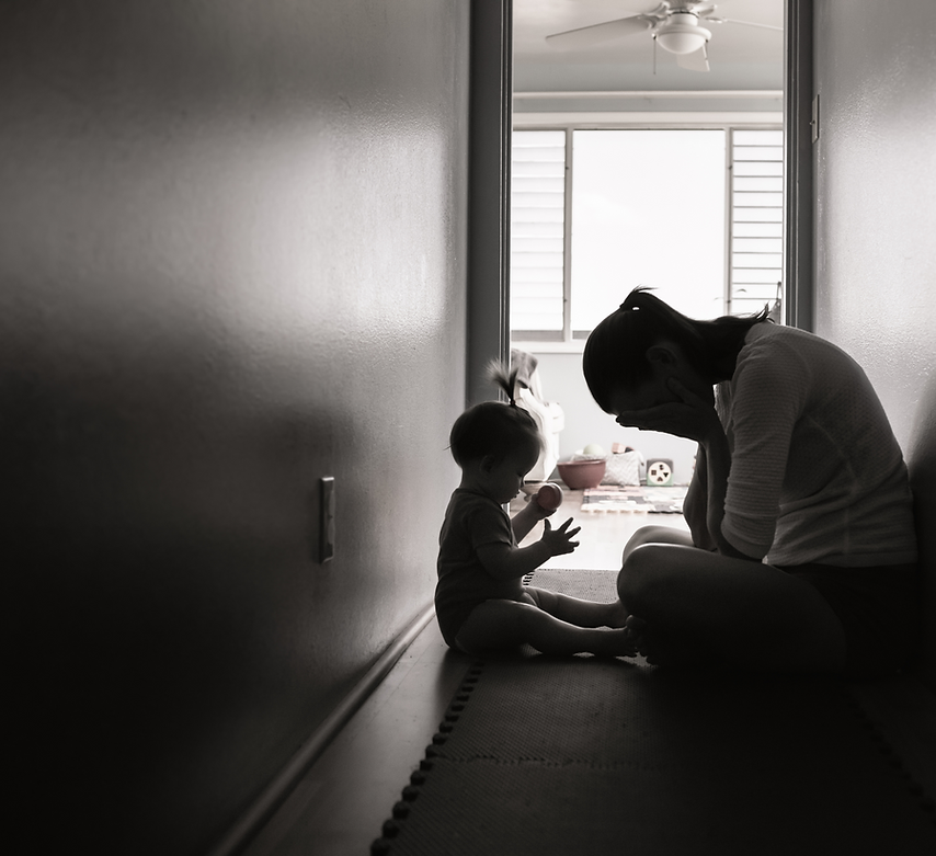 Worried mother sitting on floor with child