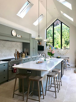 Vaulted ceiling roof windows velux feature wall kitchen island with breakfast bar entertainment space range cooker