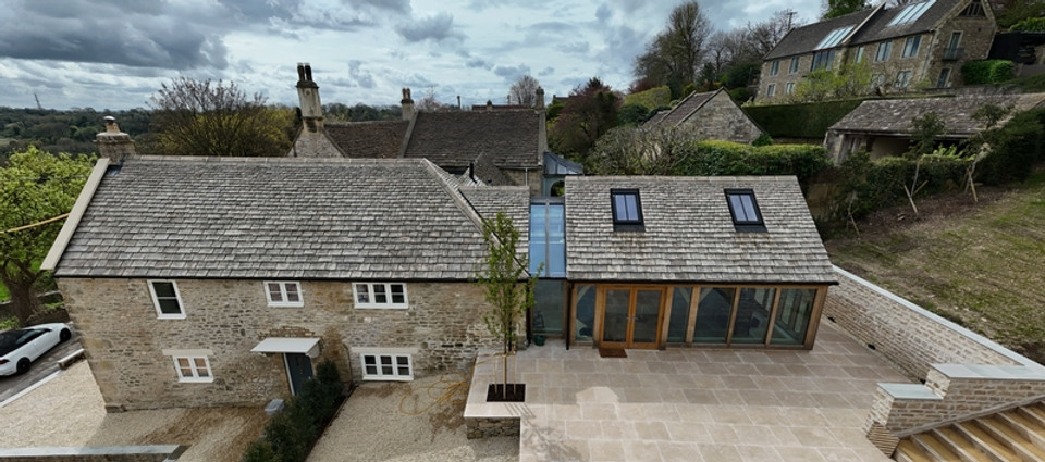Modern Cotswold stone house extension with glass walkway and garden patio in South West UK by FunLab Design Architecture Architect Frome