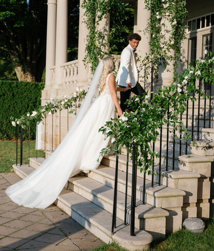 Floral Design with natural greenery on back staircase of wedding venue. 