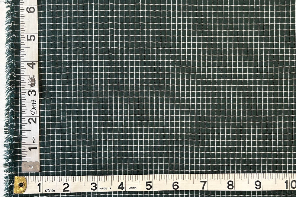 Green and white check fabric with a tape measure