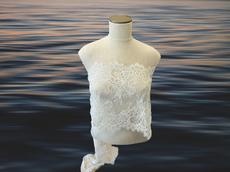 ivory chantilly alencon lace double scallop draped on a muslin mannequin with dark water in background