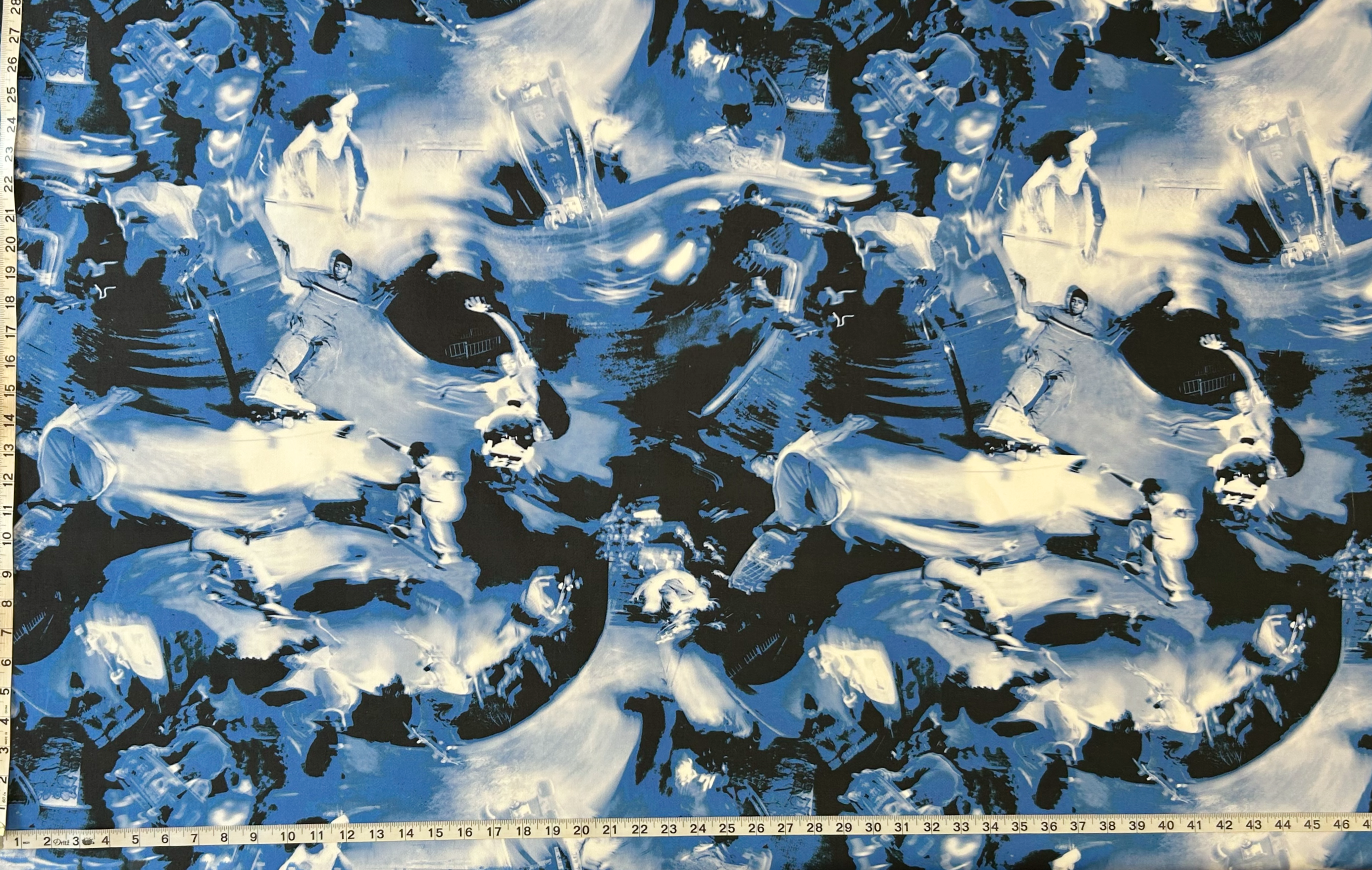 black, blue and white abstract fabric with a tape measure