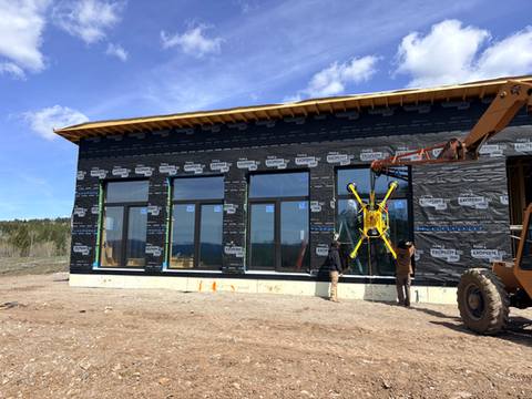 Unshakeable Custom Homes installing large floor to ceiling windows in a high performance home in Star Valley, Wyoming.