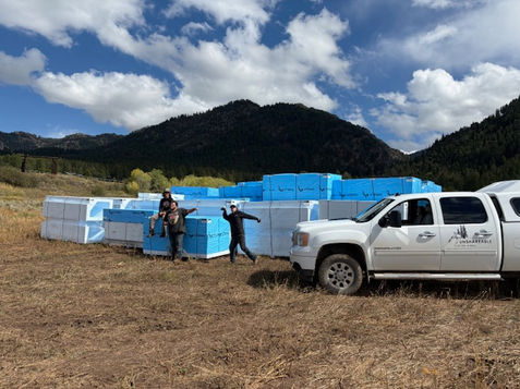 Construction workers doing a funny pose in front of a large load of structural foundation foam.