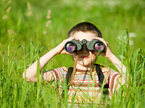 Boy using binoculars