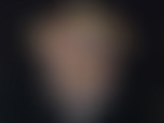 The album cover for We’ll Bring the House Down, featuring a fist bursting through a striped shield, tattooed with “SLADE,” pierced by a sword, with the album title above in bold white text.