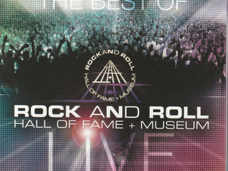 Concert‑themed cover art for The Best Of Rock And Roll Hall Of Fame + Museum Live, featuring a crowd with raised hands and the Rock Hall logo.