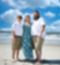 Founder of Jam Craft Co (Amanda) standing on a sandy beach with her husband and son.