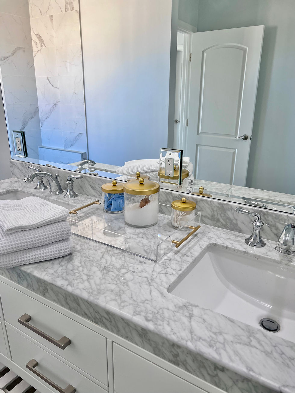 Luxury primary ensuite bathroom at an Airbnb rental on Ocean Drive featuring a soaking tub, walk-in shower, upscale coastal finishes, and professionally managed vacation rental design.