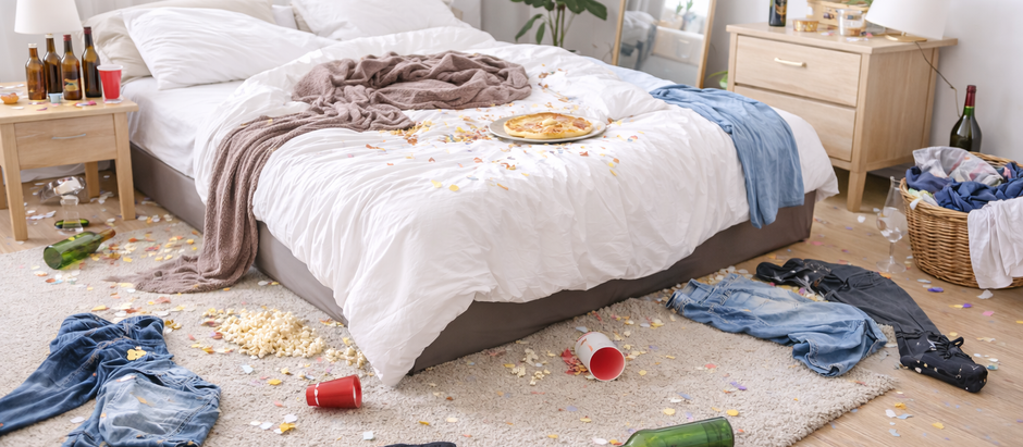 Messy Airbnb bedroom with stained linens, trash, and disorganized space after guest stay, illustrating short-term rental damage and poor property management conditions