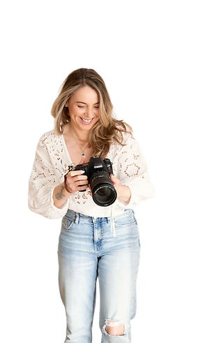 Michelle Gaskell, a friendly Cardiff photographer, smiling whilst holding her camera.