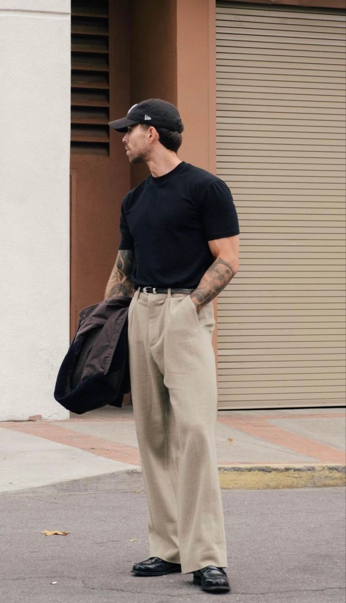 Man in black shirt and beige trousers