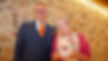 Two people at an award ceremony. The person on the right is holding the award which is a transparent star.