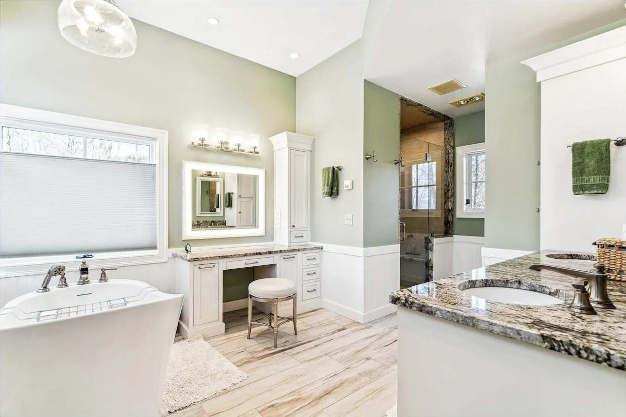 Renovated bathroom with a freestanding tub, glass shower and double vanity in Woodstock.