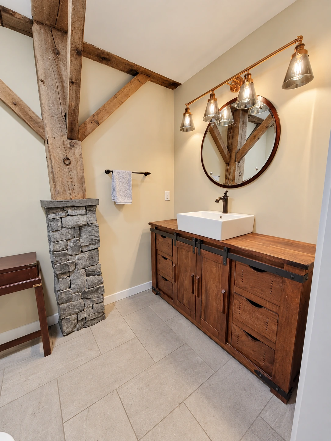 Timber posts, a stone-clad half wall and a wood vanity with a vessel sink.