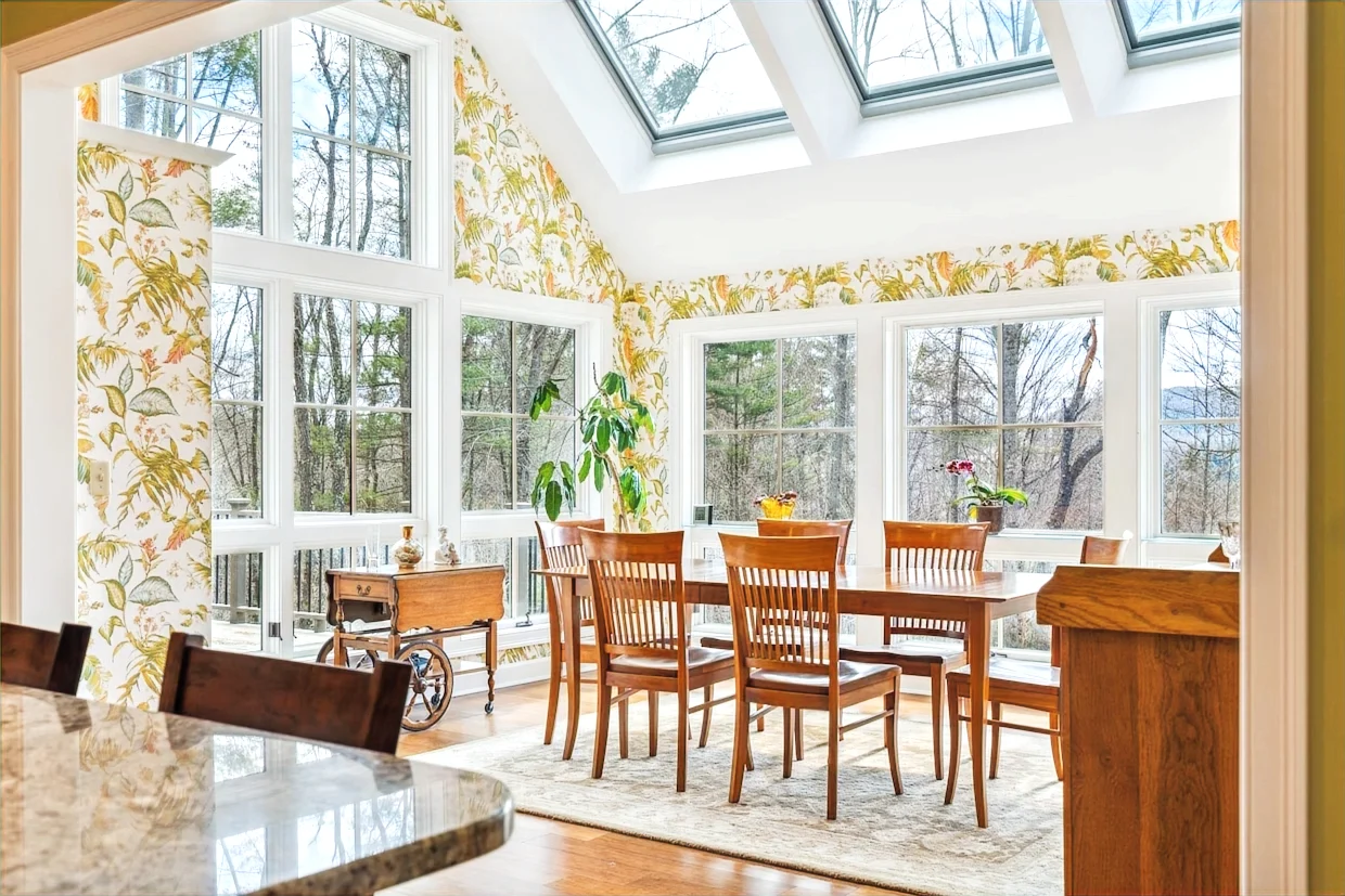 Dining room with skylights and broad garden-facing windows in a Hudson Design and Build renovation on Westerdale Road, Woodstock, Vermont.