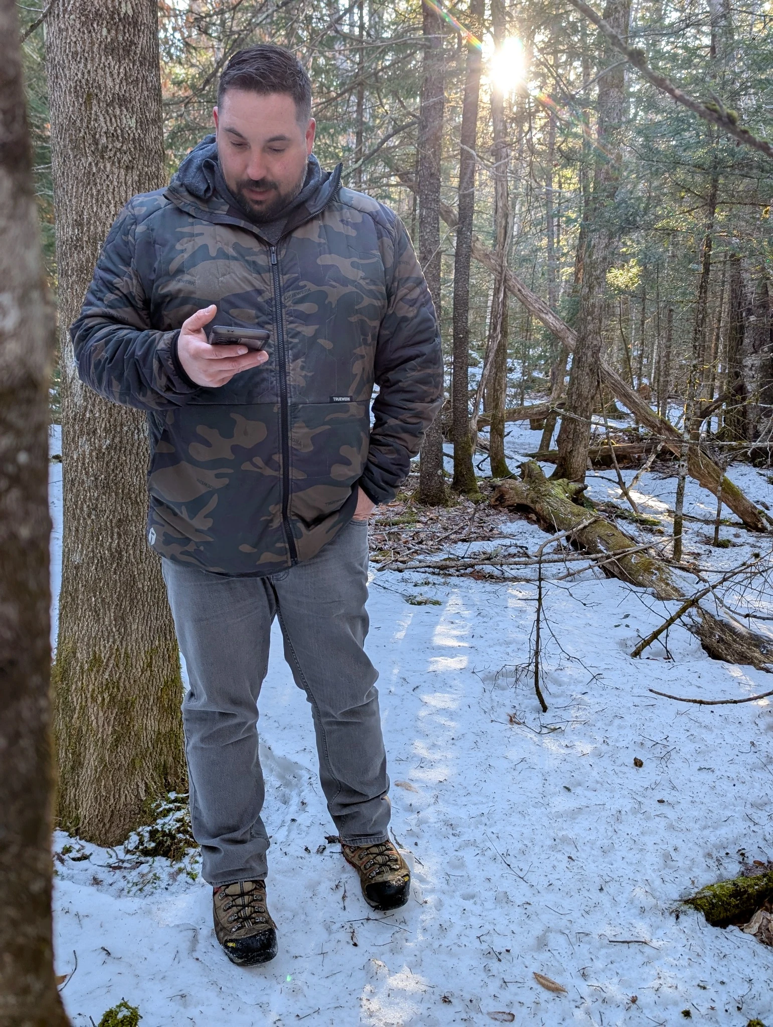 Patrick Hudson reviewing location information during a winter woodland site visit.