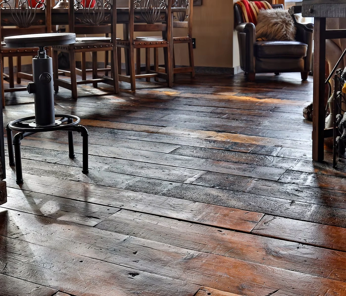 Reclaimed wood floorboards with rich brown tones, visible grain, worn edges and natural variation.