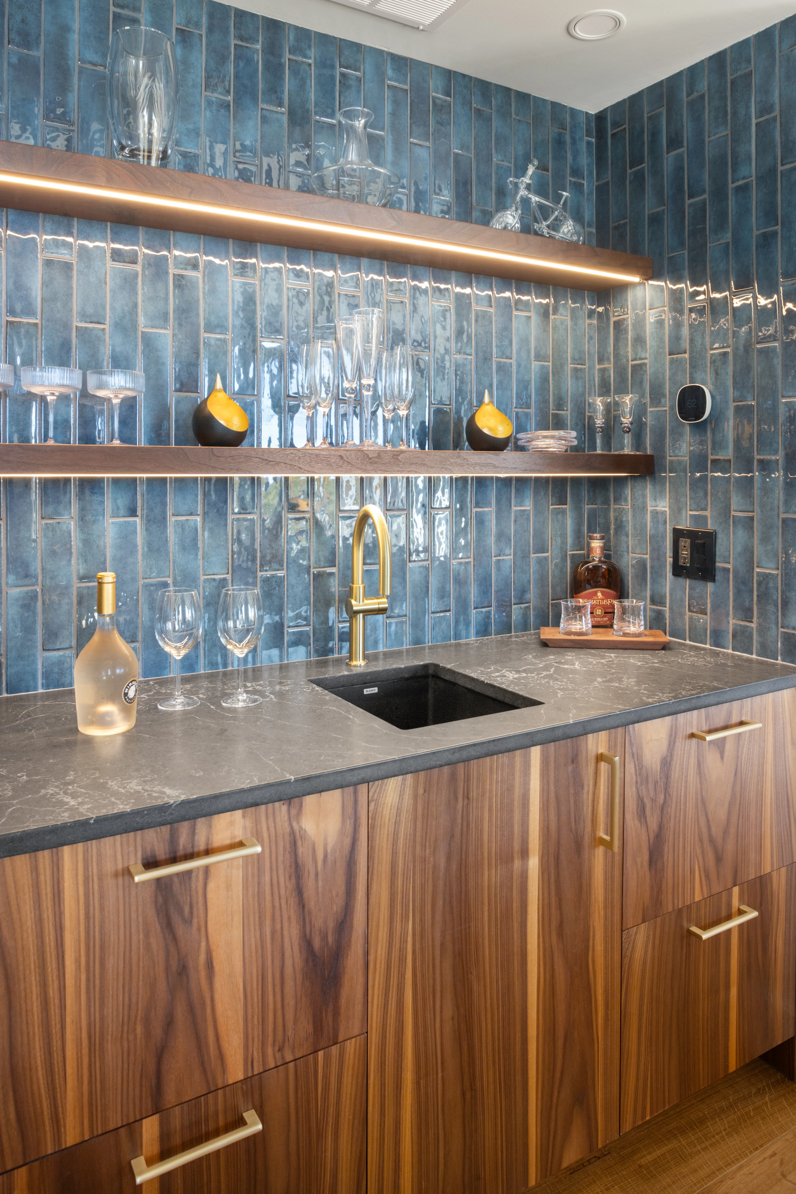 Custom wood bar cabinetry, blue tile and open shelving in Quechee.