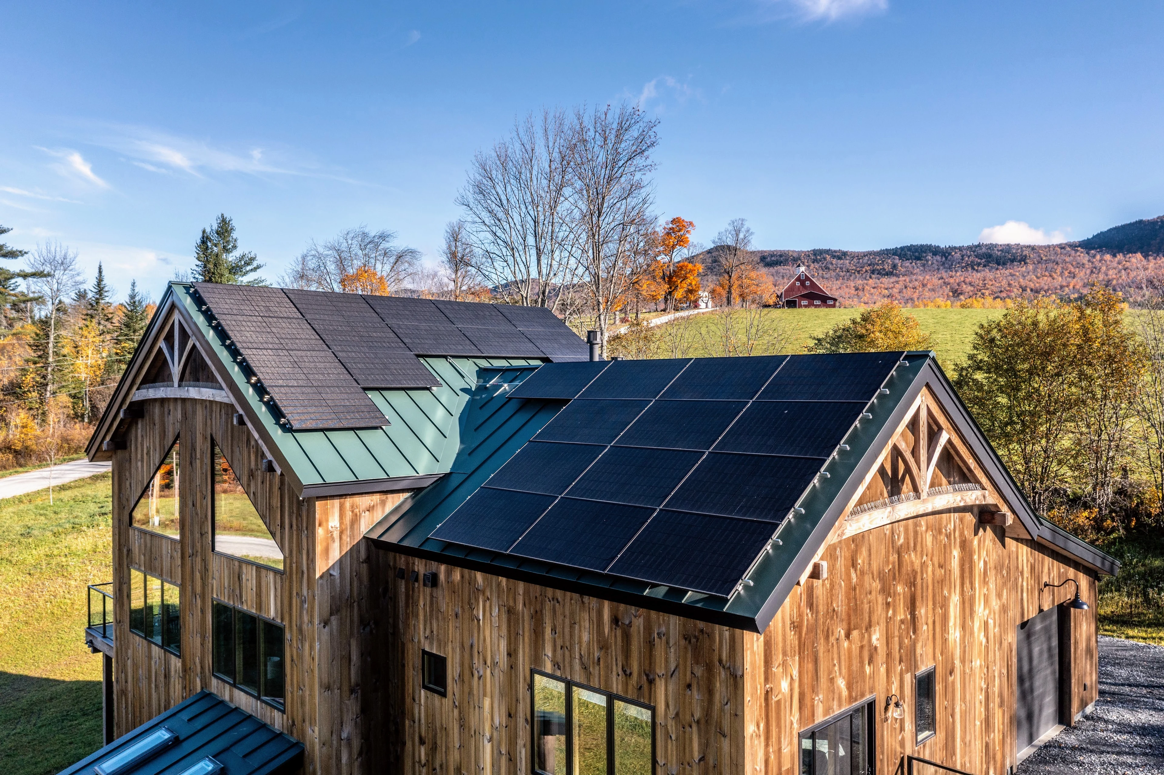 Timber gable, wood siding and rooftop solar panels on a home in Rochester, Vermont.