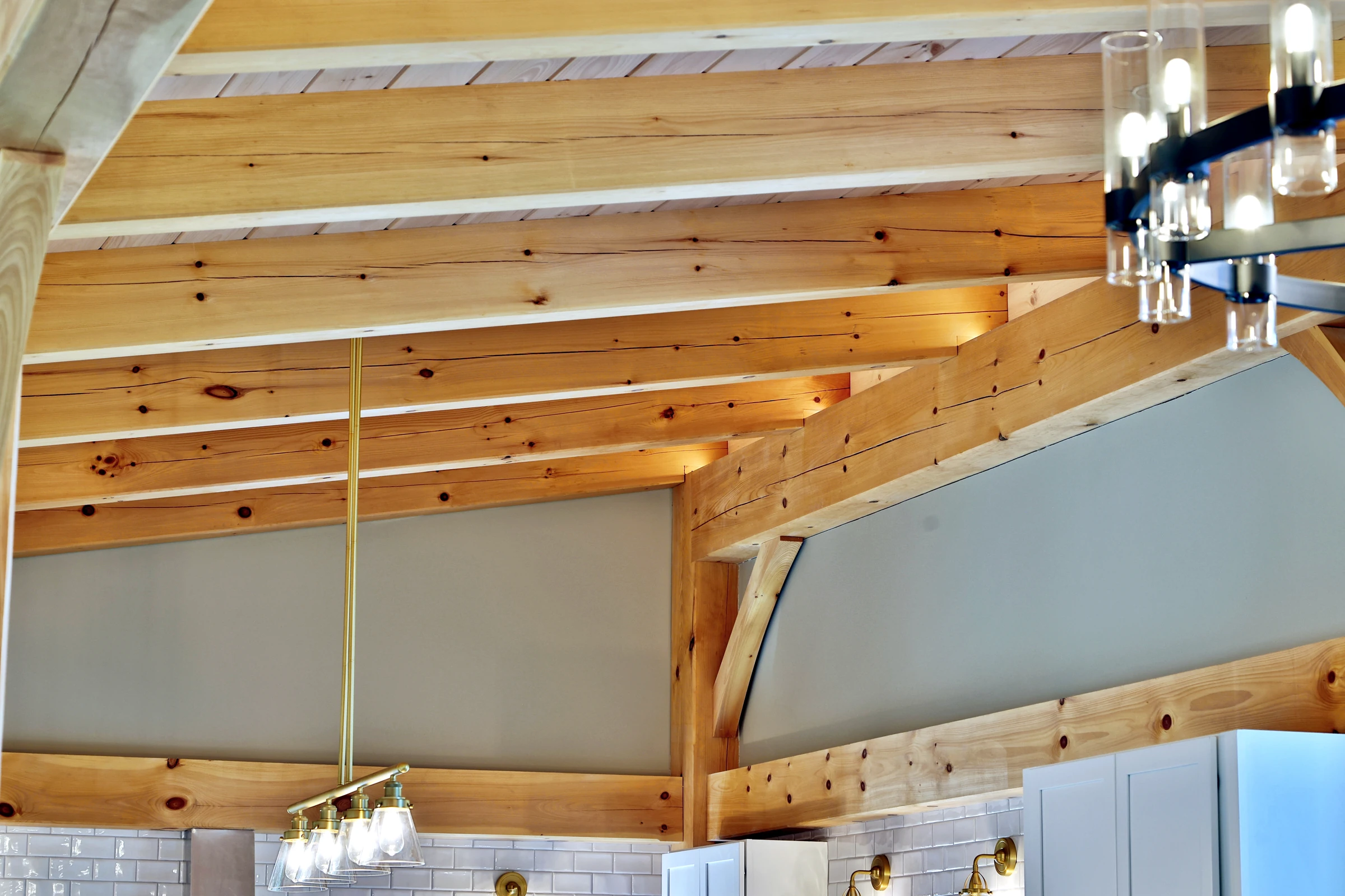 Close view of wood grain, timber braces and ceiling boards in the Killington timber frame home.