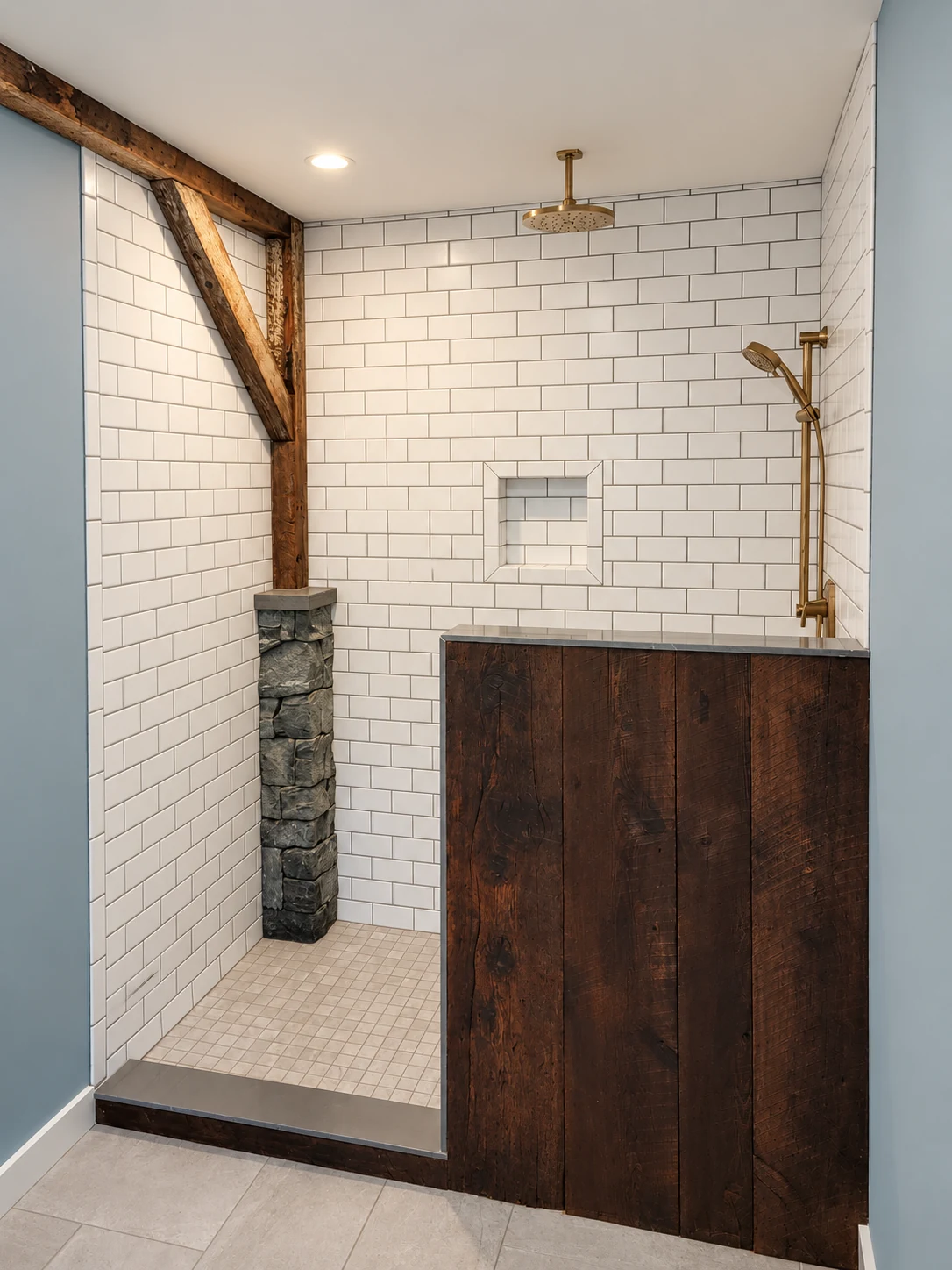 White subway tile shower with exposed timber framing, brass fittings and a dark wood accent.