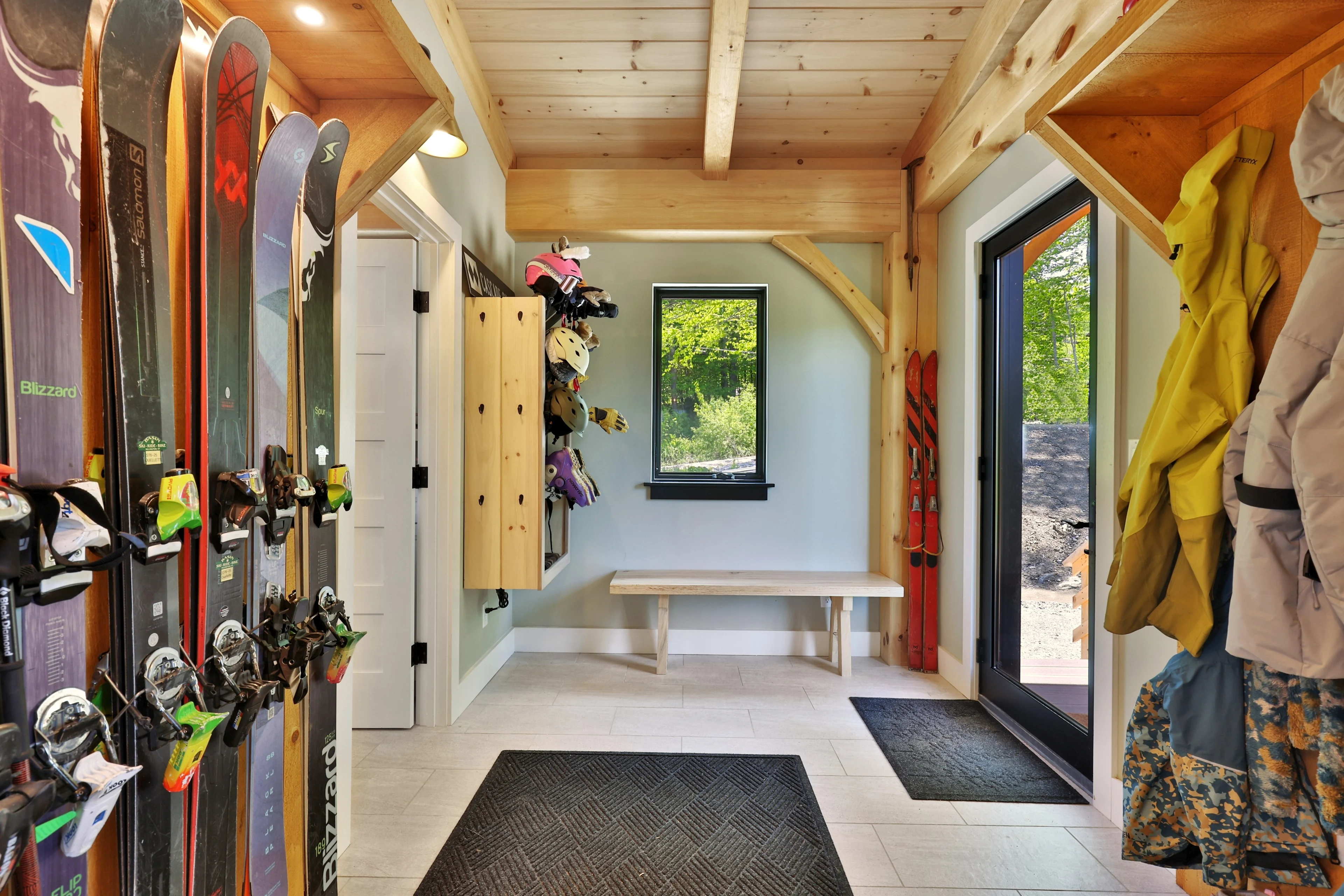 Ski racks, boot storage and exposed timber in the entry of a Killington home.