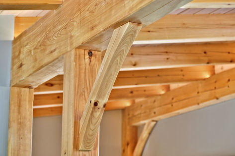 Handcrafted timber-frame beams and joinery in a Vermont custom home