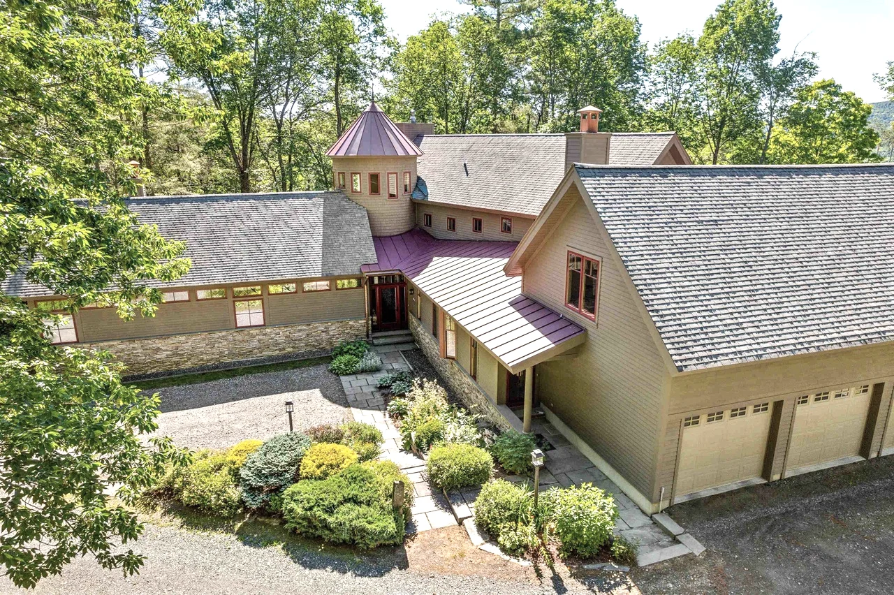 Renovated home with landscaped entry, shingle roof and stonework in Woodstock.