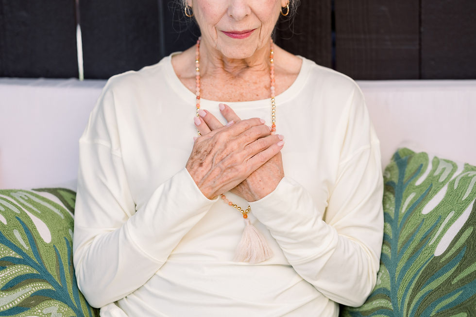 woman with hands over heart practicing grounding and emotional awareness
