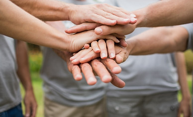 A group of people shaking hands. Team work and Events. Watchdog Management Services Community Growth and Outreach.