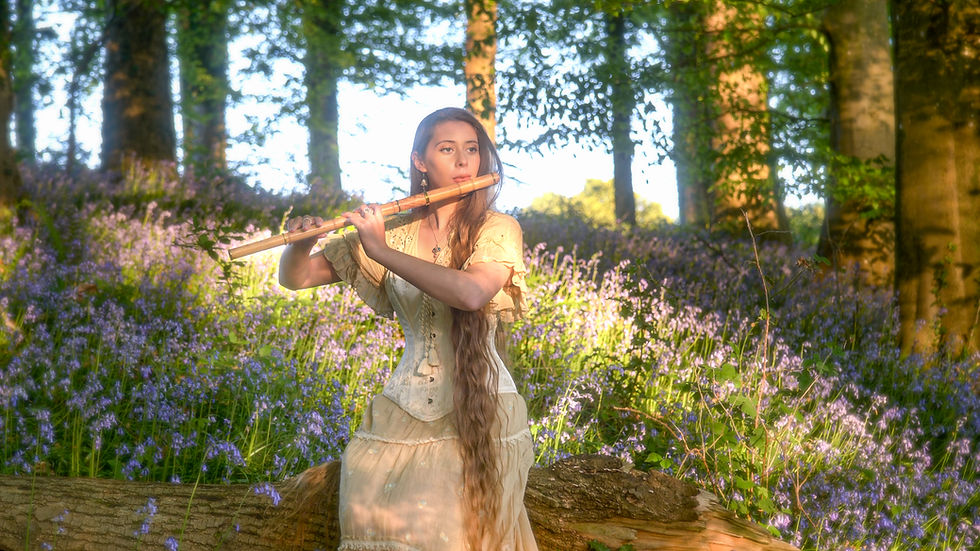 Leyna Robinson-Stone with the Clódagh Cocuswood Irish flute amongst bluebells
