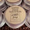 Thumbnail: a number of tins stacked on each other with a brown kraft label which reads Coffee Scrub face & body. Coffee beans in front