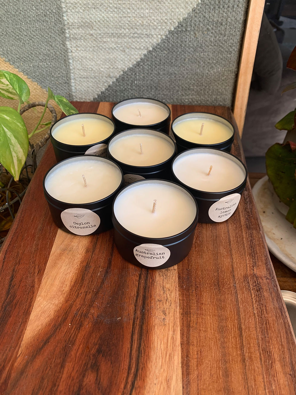 Thumbnail: a group of soy wax white candles with the lids off the tins showing clean wicks and variety of smells