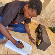 Yiya Airscience student taking notes during a live radio lesson.jpeg