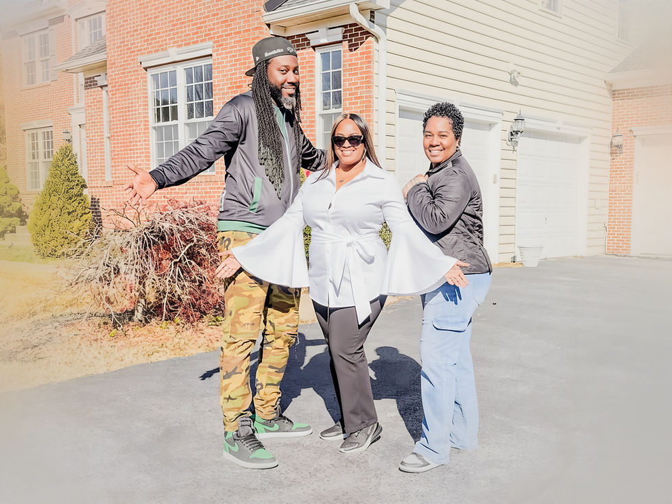 Three people standing and smiling outside a brick home