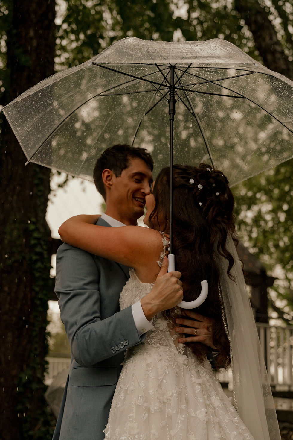 A wedding team member runs through the rain carrying the bride’s bouquet beneath a clear umbrella at Yellowbrick on 39, an Ohio wedding venue with both indoor and outdoor ceremony locations. Our rain backup plans include the staffing and coordination needed to move, reset, dry, and prepare ceremony spaces without relying on the couple, wedding party, family, or guests to do the work.