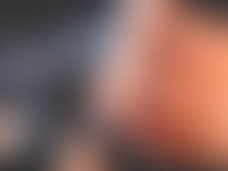 Airbrush spray tanning technician holding a spray tan gun, applying airbrush spray evenly to a woman’s stomach for a flawless tan in Houston