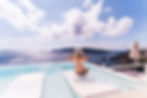 woman overlooking Greece from rooftop infinity pool
