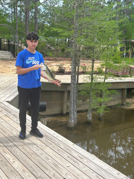 boy fishing at pond at La Hacienda Venue